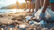 © Gethuk_Studio - Close up hand volunteer cleaning up beach collecting trash, ecology concept
