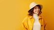 Smiling fashionable positive happy blonde caucasian woman 30s in yellow hat look camera isolated on plain yellow background studio portrait.