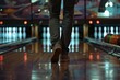 A close-up shot of a bowler's legs approaching the foul line in a bowling alley, with pins and a bowling ball in the background.