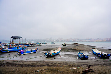 Sticker - Bali, New Taipei, Taiwan, Republic of China, 01 22 2024: Cruise ferry boat and port on Clean Tamsui river in a raining day in winter