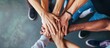 © diwek - close up of stacked human hands showing working together to build a business.