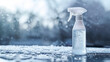 © nopommajun - A spray bottle stands on a frosty surface, surrounded by snowflakes and a winter setting suggesting car maintenance