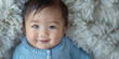 Cute little asian baby in cozy blanket. Banner with copy  space. Shallow depth of field.