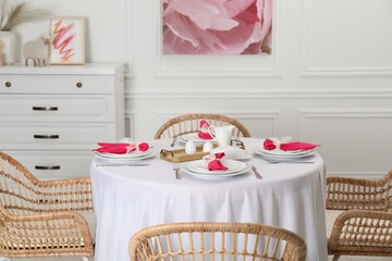 Canvas Print - Color accent table setting. Plates, cutlery and pink napkins in dining room