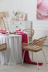 Sticker - Color accent table setting. Plates, cutlery and pink napkins in dining room