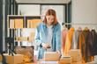online small business owner scans a barcode-labeled parcel with a barcode scanner to verify a customer's order before it is delivered to the customer..