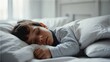 © Arceli - Close up of a sleeping child boy on a white bed in the bedroom from Generative AI