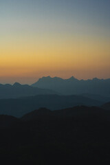 Wall Mural - nature traveling with orange sky and layer of mountain with sunrise background