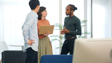 Poster - Multinational people talking while looking at laptop PC in the lobby. International business.