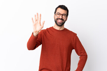 Wall Mural - Caucasian handsome man with beard over isolated white background saluting with hand with happy expression