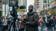 © B.Panudda - man public black speaker giving speech in front of camera covering live news media and television press headlines standing in the middle of the street holding.