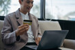 © NINENII - Male businessmen use credit cards to conduct financial transactions through phones, tablet, and laptop in the morning.