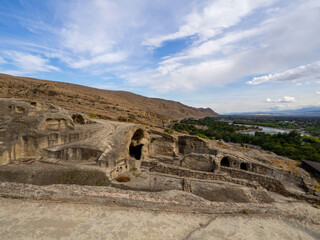 The top and good view of uplistsikhe ancient cave town with Kura river in georgia.