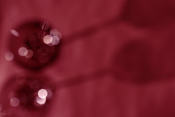 Wall Mural - wine glasses defocused, red wine color blurred background with light flare, optical blur, bokeh. top