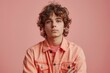 © Lukasz Czajkowski - Young Man With Curly Hair in Orange Shirt. Generative AI
