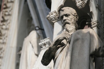 Facade of Florence Cathedral (Italian: Duomo di Firenze). Detail of a statue