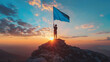 © wing - A man stands on a snow-covered mountain peak, holding a blue flag. The sun shines brightly in the background.