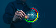 © thanmano - A man is pointing at a risk management level on a screen