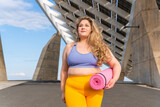 Fototapeta Nowy Jork - Beautiful plus size young woman outdoors - Confident chubby oversize female model strolling in the city, concepts about diversity, body acceptance and body positive