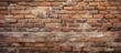© TheWaterMeloonProjec - An old brick wall with a weathered texture serves as the backdrop for a sign attached to it. The sign is prominently displayed against the rugged surface of the bricks.