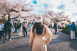 Fototapeta Miasto - Traveler asian woman travel in sakura cherry blossom  tree in Chidorigafuchi park Tokyo Japan in spring season