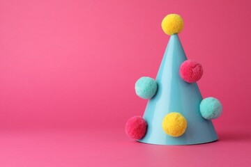 Canvas Print - One light blue party hat with pompoms on pink background. Space for text