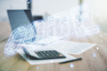 Wall Mural - code word hologram on blurry calculator and computer background, international software development 