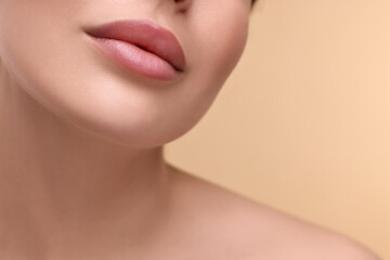 Poster - Woman with beautiful lips on beige background, closeup. Space for text