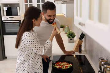 Poster - Happy lovely couple cooking together in kitchen