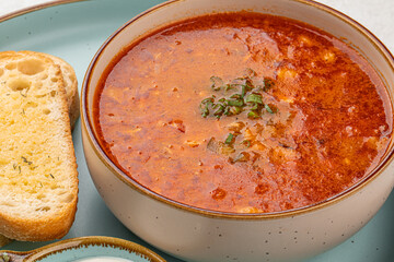 Wall Mural - Portion of slavic traditional red sour soup borscht with toast and cream