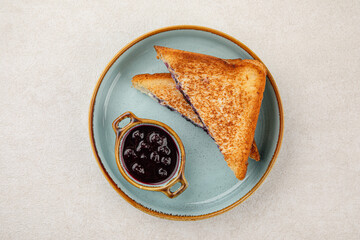 Wall Mural - Portion of sweet sandwich with berry jam breakfast