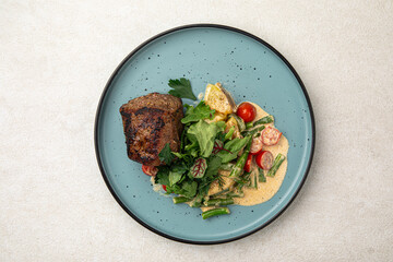 Canvas Print - Portion of grilled beef mignon steak with vegetables