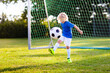 © famveldman - Kids play football. Child at soccer field.