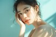 © jirayut - Young Asian beauty woman with korean makeup style, perfect clean skin on isolated blue background. Facial treatment, Cosmetology, plastic surgery.
