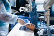 Hands of ophtalmology surgeons and assistants with ophtalmological surgery tools during surgical treatment. Eye disinfection. Doctor wears gloves