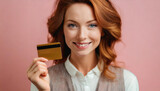 Fototapeta Sport - Smiling woman holds her credit card in her hand 