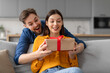 © Prostock-studio - Excited couple sharing surprise gift at home, man giving present to wife
