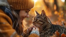 Portrait Of Young Woman Holding Cute Cat With Green Eyes. Female Hugging Her Cute Long Hair Kitty. Background, Copy Space, Close Up.