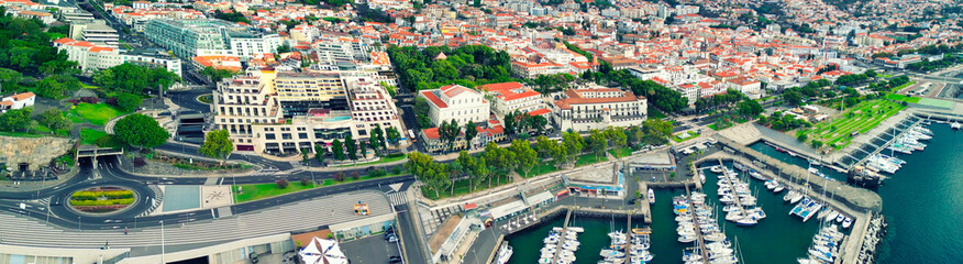 Wall Mural - Funchal, Madeira. Aerial view of city center from a drone flying over the port