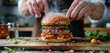 © ArtCookStudio - Hamburger Being Prepared on a Cutting Board