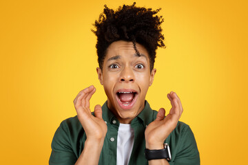 Wall Mural - Closeup of african american man screaming over yellow background