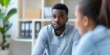 Supportive Therapy A Young Black Man Finds Solace Discussing With A Psychologist At A Mental Health Clinic. Concept Mental Health Support, Therapy Sessions, Healing Conversations