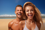 Fototapeta Do akwarium - Happy young couple having fun on the beach. They are laughing and looking at the camera.
