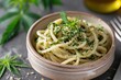 Cannabis culinary. Cannabis pesto pasta in a bowl. Italian cuisine with hemp leaves for a cannabis culinary concept