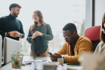 Canvas Print - Focused business coworkers using smart phone during collaborative team meeting at office.