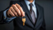 A realtor in a gray suit. Sale and rental of real estate. Close-up photo of a hand holding keys. Generated by AI
