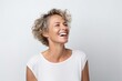 Beautiful middle aged woman with short wavy hair laughing and looking up.