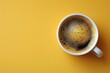 Top view image of coffe cup on wooden yellow background. Flat lay. Copy space