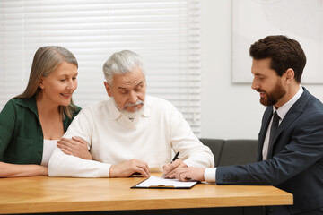 Sticker - Notary showing senior couple where to sign Last Will and Testament in office