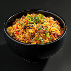 Wall Mural - A colorful bowl of Korean fried rice garnished with spring onions on a dark background.